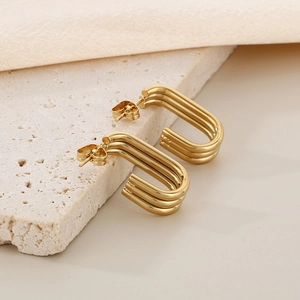 Modern triple-layered U-shaped 18K gold plated stainless steel earrings on stone