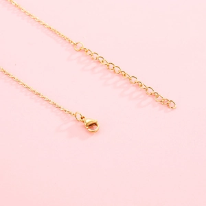 Minimalist 18k gold zodiac necklace featuring a lobster clasp and extension chain detail