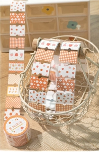 Detailed view of floral washi tape with strawberry and cherry patterns in a white basket
