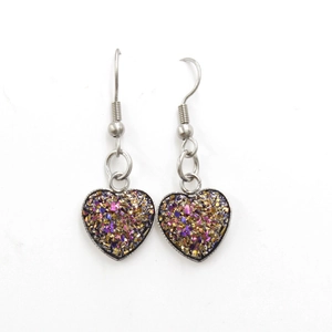Detail of silver heart earrings with colorful sparkling glitter inlay and hook