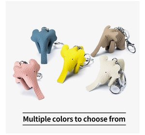 Detailed view of leather elephant keychains in blue, yellow, pink, beige and brown
