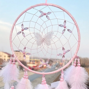 Pink handmade dreamcatcher with feathers and purple butterfly for room decoration