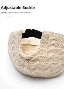 Detail of beige knitted baseball cap featuring adjustable black strap buckle for custom fit