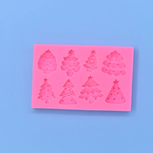Pink silicone mold featuring eight diverse Christmas tree shapes for baking and DIY crafts