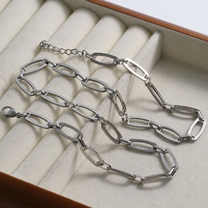 Close-up of polished silver stainless steel hollow link chain with a lobster clasp