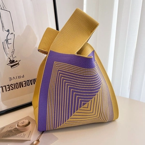 Detailed knit tote bag with purple and yellow geometric patterns in a lifestyle setting