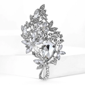 Macro detail of silver floral brooch with clear crystals and water-drop main stone
