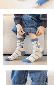 Detail shot of striped cotton socks for kids featuring a blue and yellow car pattern