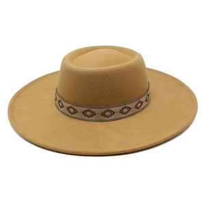 Detail of khaki wool felt fedora featuring an ethnic embroidered diamond pattern band
