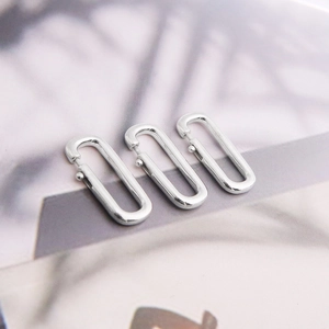 Macro shot of three polished S925 sterling silver oval spring clasps for DIY jewelry making