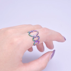 Macro view of rainbow titanium steel chain ring with iridescent metal links on model hand