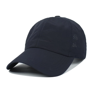 Detail showing the breathable side mesh and durable fabric of the navy ponytail baseball cap
