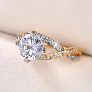 Macro shot of a four-prong round zircon ring with a two-tone twisted pavé band