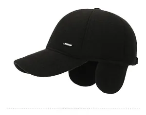 Side view of black knitted baseball cap with ear flaps and metal logo for winter