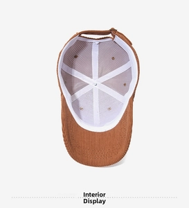 Detailed view of the brown corduroy baseball cap interior with white reinforced stitching