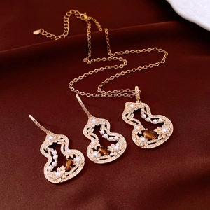 Detailed view of vintage jewelry set with tiger eye gourd pendants and pearls