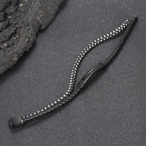 Detail of multi-layer woven black leather bracelet with silver beads and magnetic clasp