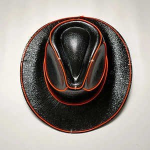 Detail of black LED cowboy hat with glowing orange EL wire and textured leather finish
