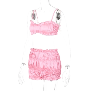 Detail of pink satin camisole set with ruffle hem and drawstring shorts on mannequin