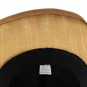 Detail of western cowboy hat interior showing 100% paper material label and sweatband