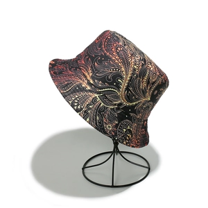 Detail of bohemian paisley pattern bucket hat with vibrant orange and red mandala prints