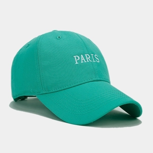 Detail view of mint green baseball cap with white PARIS embroidery on twill fabric