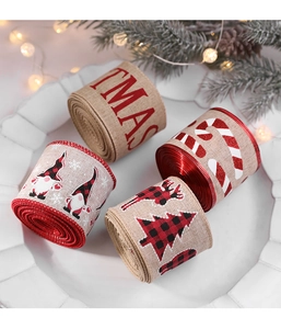 Detailed view of four rustic Christmas linen ribbon rolls in festive tray with pine décor