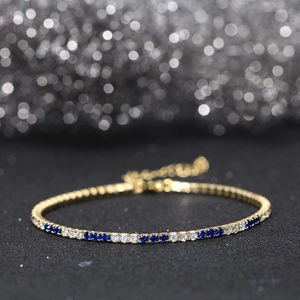 Detail of s925 silver tennis bracelet with alternating blue and clear cubic zirconia