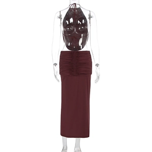Detail of high-waisted burgundy skirt featuring horizontal pleats and back lace-up closure