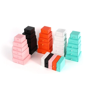 Colorful drawer jewelry gift boxes with ribbon handles in pink, black, and white