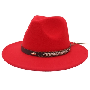 Detail of red wool felt fedora with decorative braided leather strap and metal studs