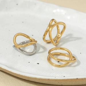 Minimalist gold and silver stainless steel rings with geometric crossed line design