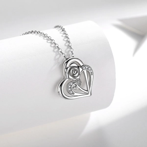 Silver heart necklace with rose design and micro-paved zircons on a white background