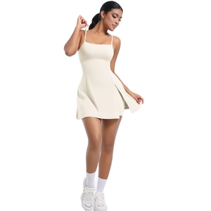 Detailed view of cream tennis dress featuring thin straps and pleated A-line mini skirt