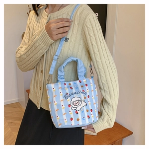 Detail of light blue striped canvas bucket bag with cute sheep design and ruched handle