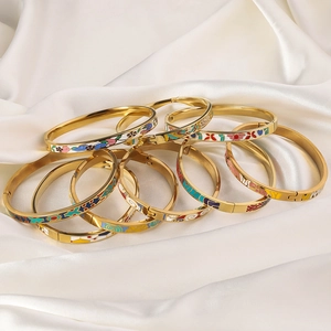 Detail of colorful enamel pattern on a polished 18K gold-plated titanium steel bangle