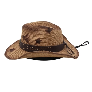 Detail of western straw cowboy hat with star patterns and studded leather hat band