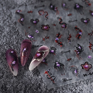 Gothic nail stickers with purple gems and spider webs on dark textured background