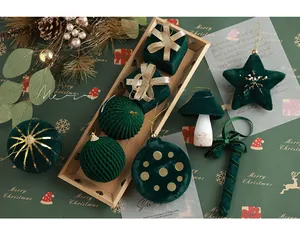 Detail of dark green velvet Christmas ornaments with gold embroidery and ribbon accents