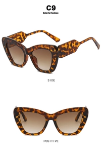 Detail view of cat eye glasses frames with tortoiseshell texture and brown gradient lenses