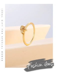 Close-up of golden palm tree ring displayed on minimalist geometric jewelry stand