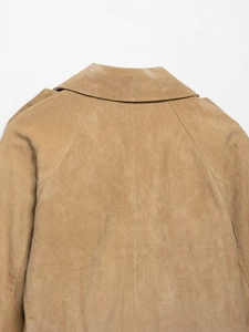 Detail of camel suede jacket showing high-quality stitching and collar texture