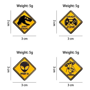 Set of 4 yellow enamel pins featuring dinosaur, gamer zone, area 51, and UFO designs