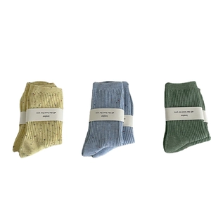 Three pairs of cotton crew socks with colorful speckle knit in yellow blue and green colors