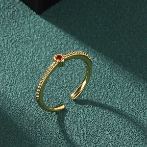 Exquisite 18K gold-plated teardrop ring featuring a small red gemstone on a textured band