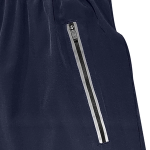 Detail of navy blue sports shorts featuring a functional zipper pocket and reflective strip