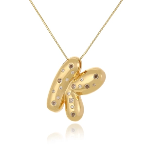 Close-up of 18k gold plated letter K pendant with sparkling cubic zirconia on a fine chain