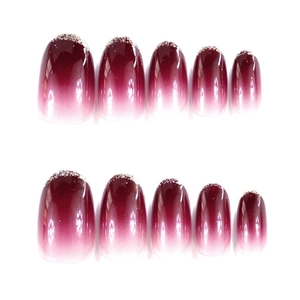 Gradient burgundy press-on nails with golden glitter tips and oval shape design