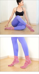 Detail of pink five-toe yoga socks with non-slip silicone grips on the soles