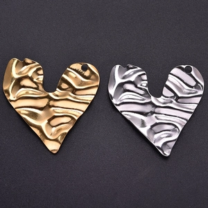 Detailed view of 304 stainless steel heart pendants with hammered texture and top holes